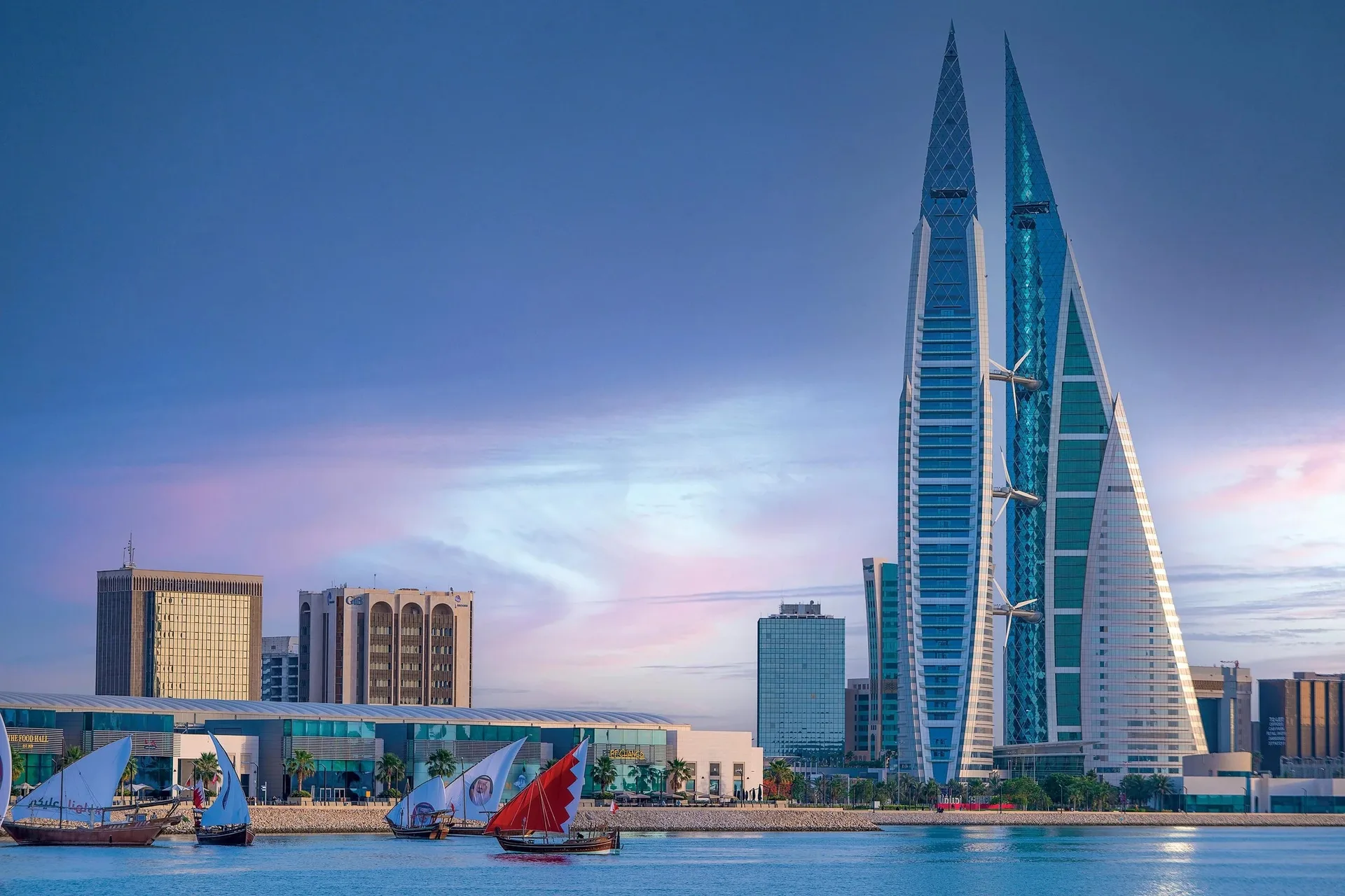 Dhows on the water in front of the Bahrain World Trade Center at dusk