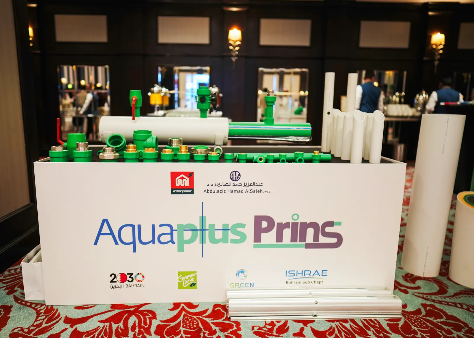 Aquaplus Prins exhibition stand with pipe fittings, photographed at the event covered by Al Ayam