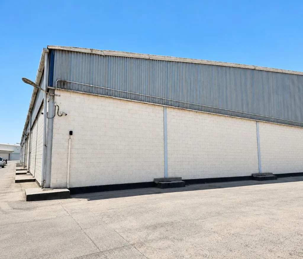 Industrial warehouse corner and loading platforms in Sitra Industrial Area